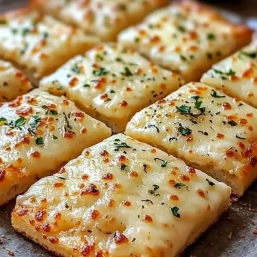 Christmas Braised Lamb Shanks with Herb Infusion garnished with fresh herbs