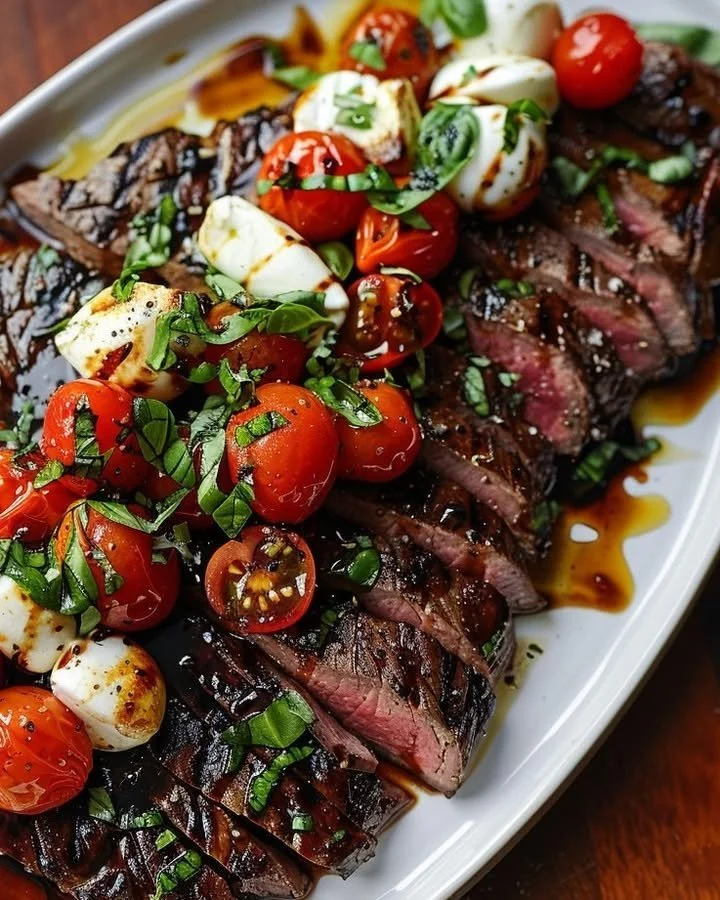 Grilled balsamic flank steak caprese topped with fresh tomatoes and basil