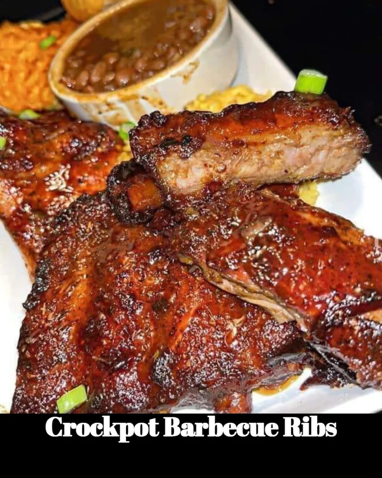 Crockpot barbecue ribs served on a plate with barbecue sauce