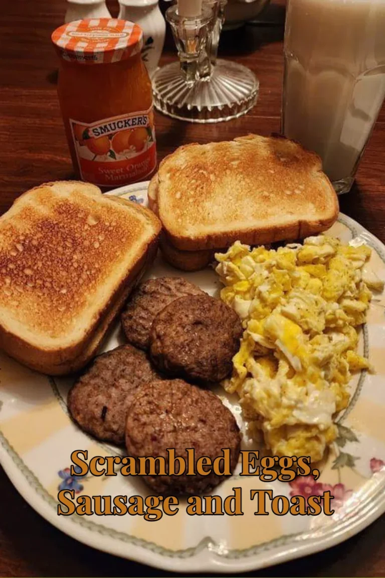 Plate of scrambled eggs served with sausage and toasted bread for breakfast