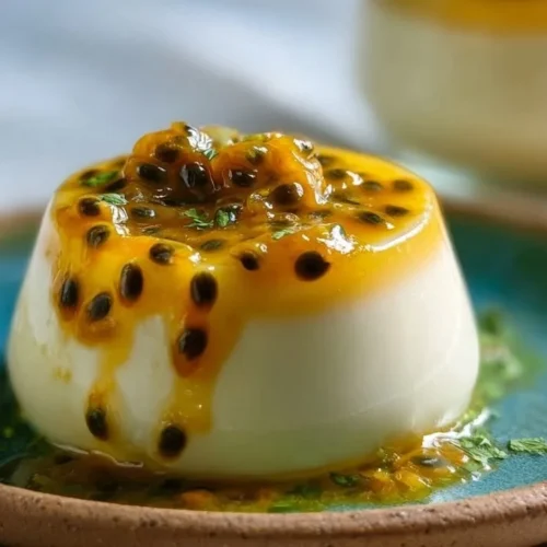 Delicious Passion Fruit Panna Cotta served in a glass with fresh fruit garnish