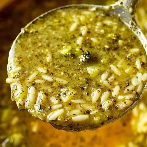 Bowl of warming Italian Broccoli Soup garnished with fresh herbs.