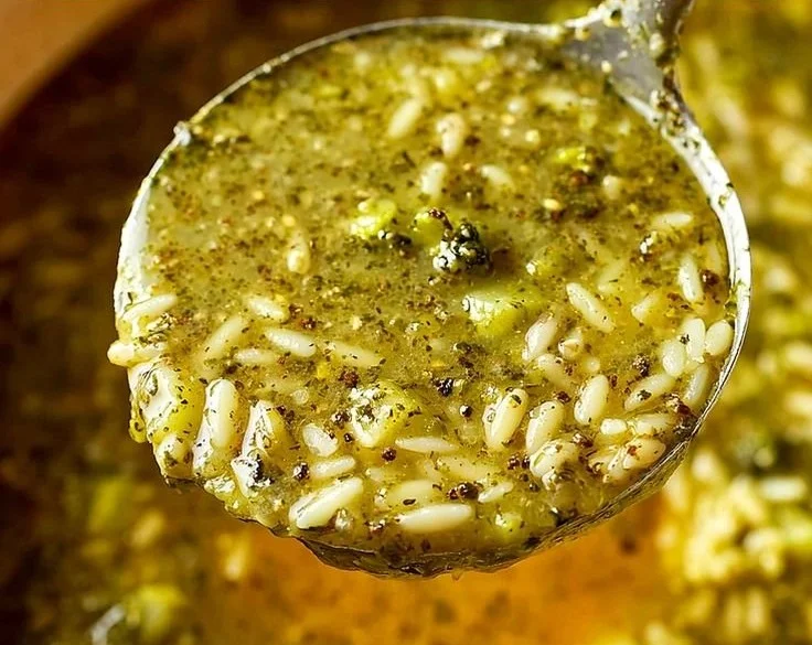 Bowl of warming Italian Broccoli Soup garnished with fresh herbs.