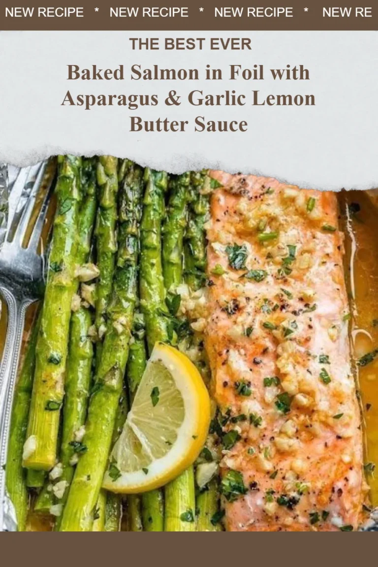Baked salmon in foil served with asparagus and garlic lemon butter sauce.
